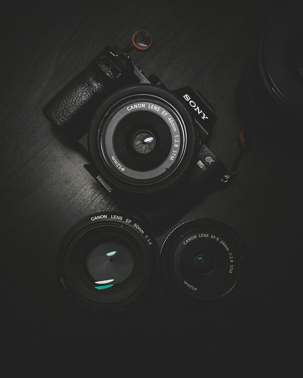 Professional camera and lenses on a dark surface