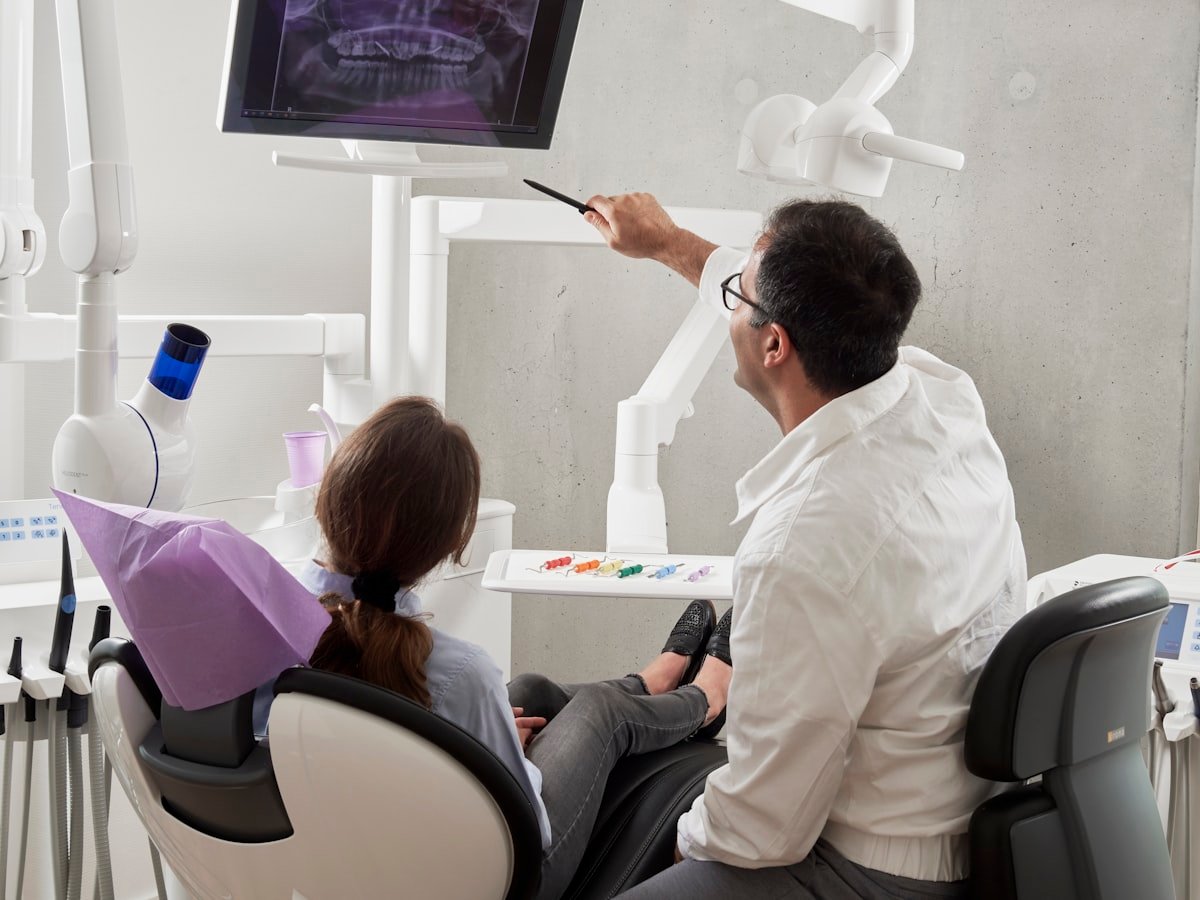 Dentist explaining an x-ray to a patient in the treatment chair