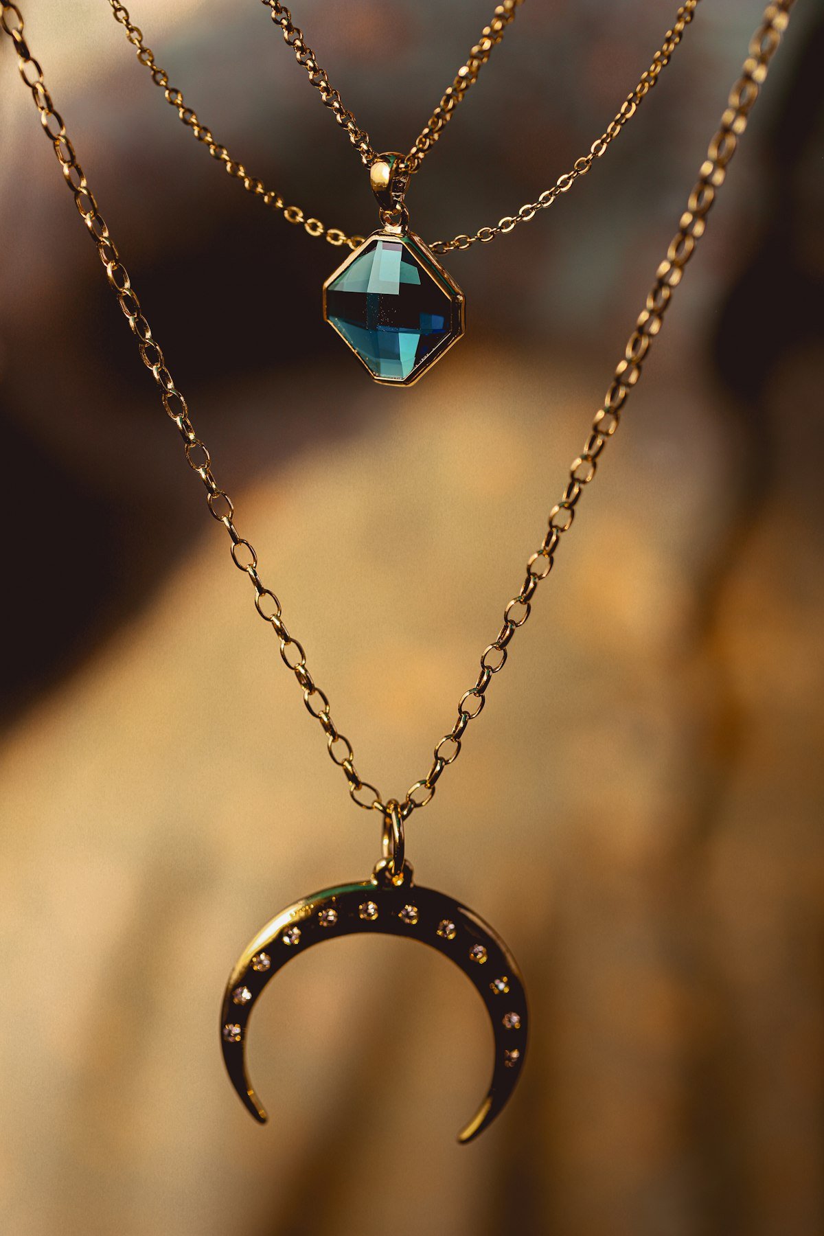 Gold layered necklaces with gemstone pendants for a jewelry store product page